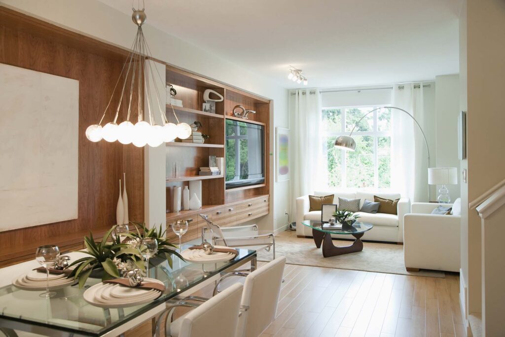 Stylish open-plan condo interior with dining and living areas — designed for comfort, balance, and efficient use of space by interior design experts.